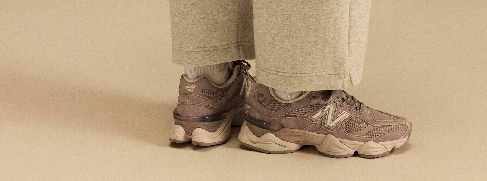 Side profile on-figure shot of the tan and beige shoes. 